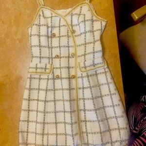 Cute white dress embellished with gold chain links with tinting of blue lines